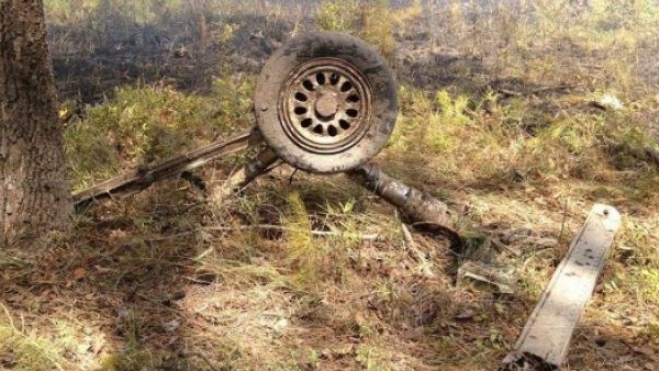 A wheel and landing gear assembly is photographed in a wooded area near the scene where an F-16, small plane collided in South Carolina on July 7,2015. (Photo: WCBD)