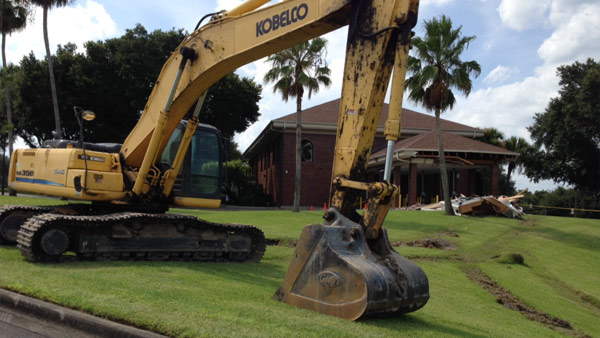 The damage done by the backhoe to the bank building. 