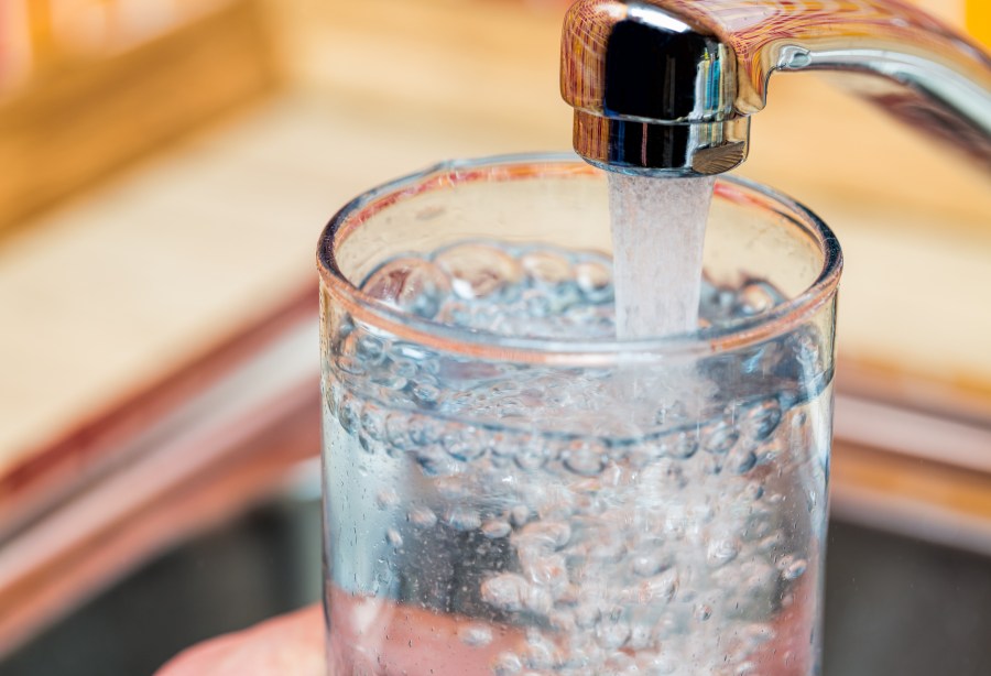 Filling up a glass with drinking water from kitchen tap_197175