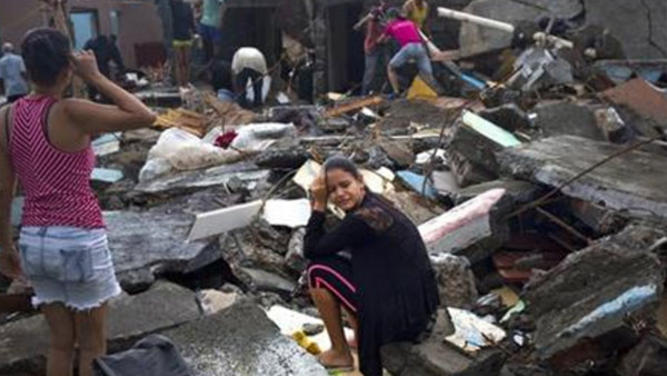 A woman cries amid the rubble of her home, destroyed by Hurricane Matthew, in Baracoa, Cuba, Wednesday, Oct. 5, 2016. The hurricane rolled across the sparsely populated tip of Cuba overnight, destroying dozens of homes in Cuba's easternmost city,...