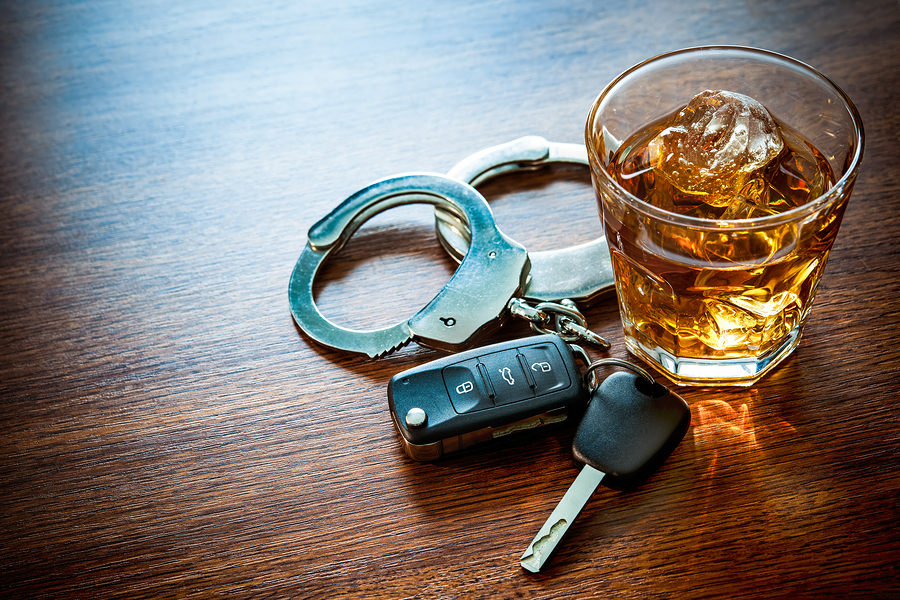 Whiskey with car keys and handcuffs concept for drinking and dri_245392