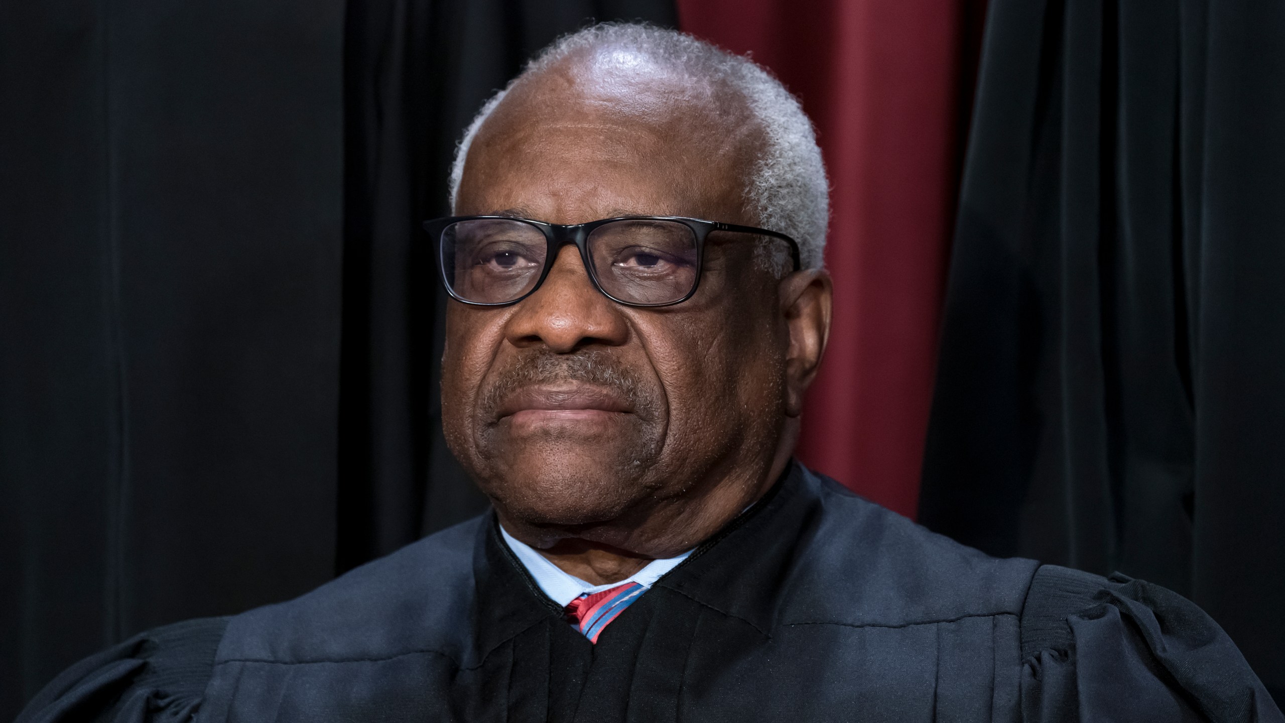 FILE - Associate Justice Clarence Thomas joins other members of the Supreme Court as they pose for a new group portrait, at the Supreme Court building in Washington, Oct. 7, 2022. Thomas has for more than two decades accepted luxury trips nearly every year from Republican megadonor Harlan Crow without reporting them on financial disclosure forms, ProPublica reports. (AP Photo/J. Scott Applewhite, File)