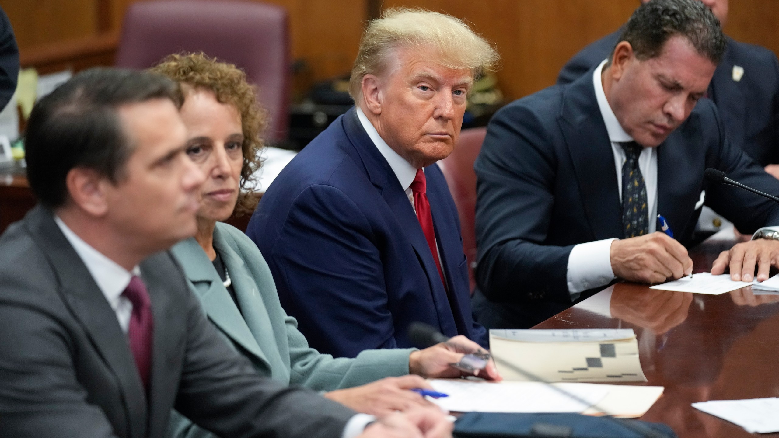 FILE - Former President Donald Trump sits at the defense table with his legal team in a Manhattan court, Tuesday, April 4, 2023, in New York. Trump appeared in court on charges related to falsifying business records in a hush money investigation, the first president ever to be charged with a crime. (AP Photo/Seth Wenig, Pool)