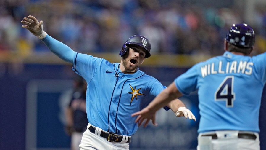 Tampa Bay Rays' Brandon Lowe celebrates with third base coach Brady Williams (4) after his solo home run off Boston Red Sox relief pitcher Chris Martin during the eighth inning of a baseball game Monday, April 10, 2023, in St. Petersburg, Fla. (AP Photo/Chris O'Meara)