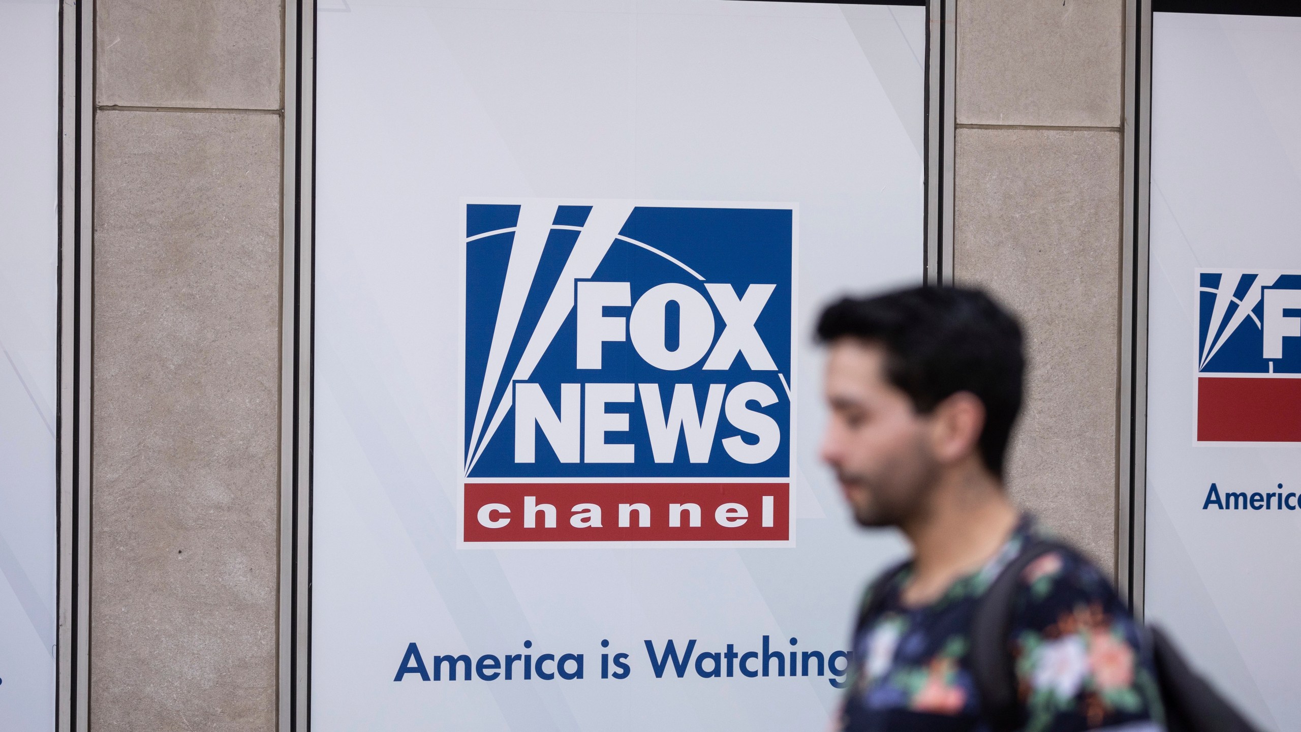 FILE - A person walks past the Fox News Headquarters in New York, April 12, 2023. The Delaware judge overseeing Dominion Voting Systems' $1.6 billion defamation lawsuit against Fox News announced late Sunday, April 16, that he was delaying the start of the trial until Tuesday, April 18. He did not cite a reason. The trial, which has drawn international interest, had been scheduled to start Monday morning with jury selection and opening statements. (AP Photo/Yuki Iwamura, File)