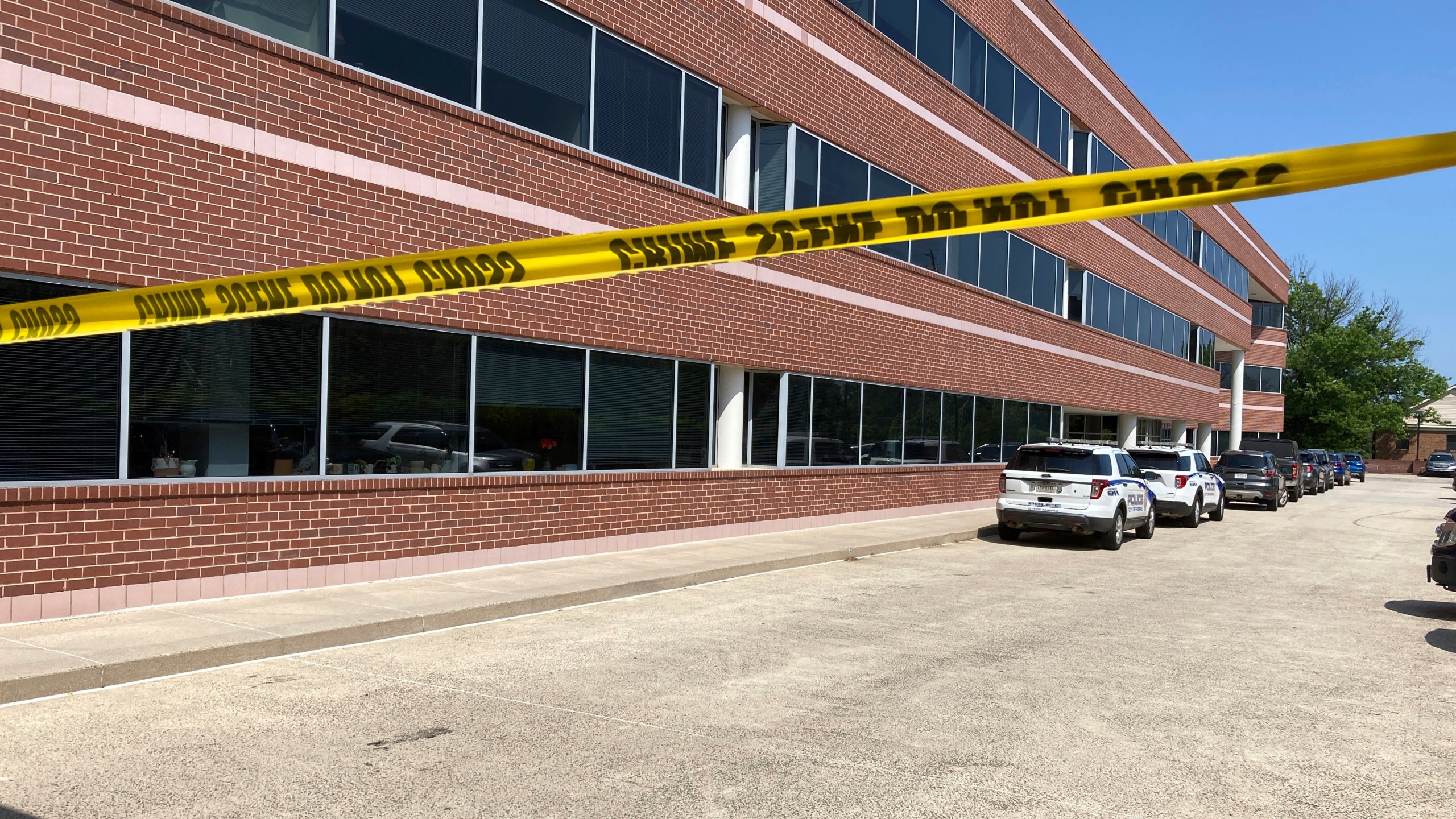 Crime scene tape blocks the Fairfax, Va., office building where police say a man wielding a baseball bat attacked two staffers for U.S. Rep. Gerry Connolly, D-Va., on Monday morning, May 15, 2023. (AP Photo/Matthew Barakat)