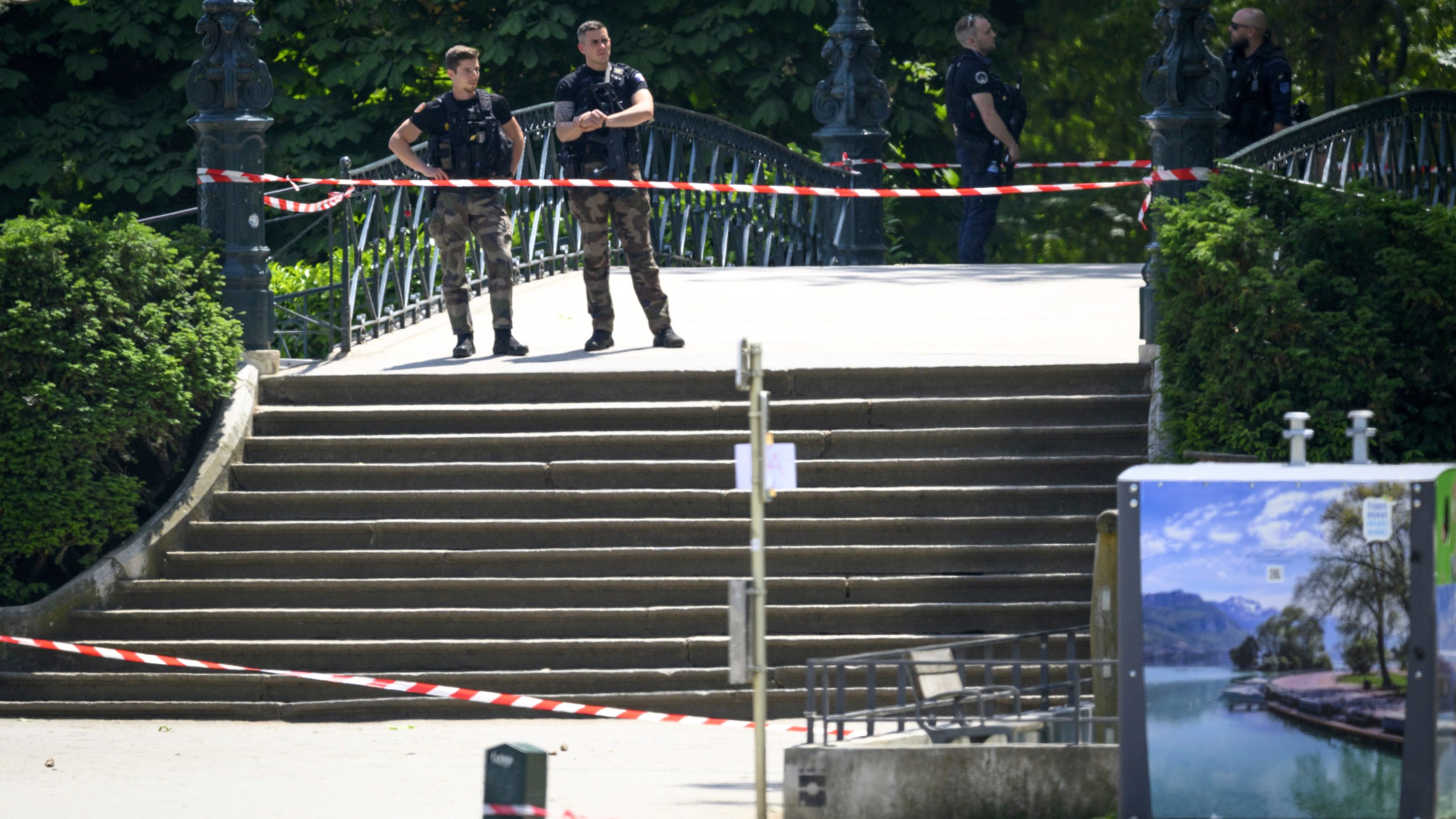 CORRECTS SLUG - Security forces gather at the scene of knife attack in Annecy, French Alps, Thursday, June 8, 2023. An attacker with a knife stabbed several young children and at least one adult, leaving some with life-threatening injuries, in a town in the Alps on Thursday before he was arrested, authorities said. (Jean-Christophe Bott/Keystone via AP)