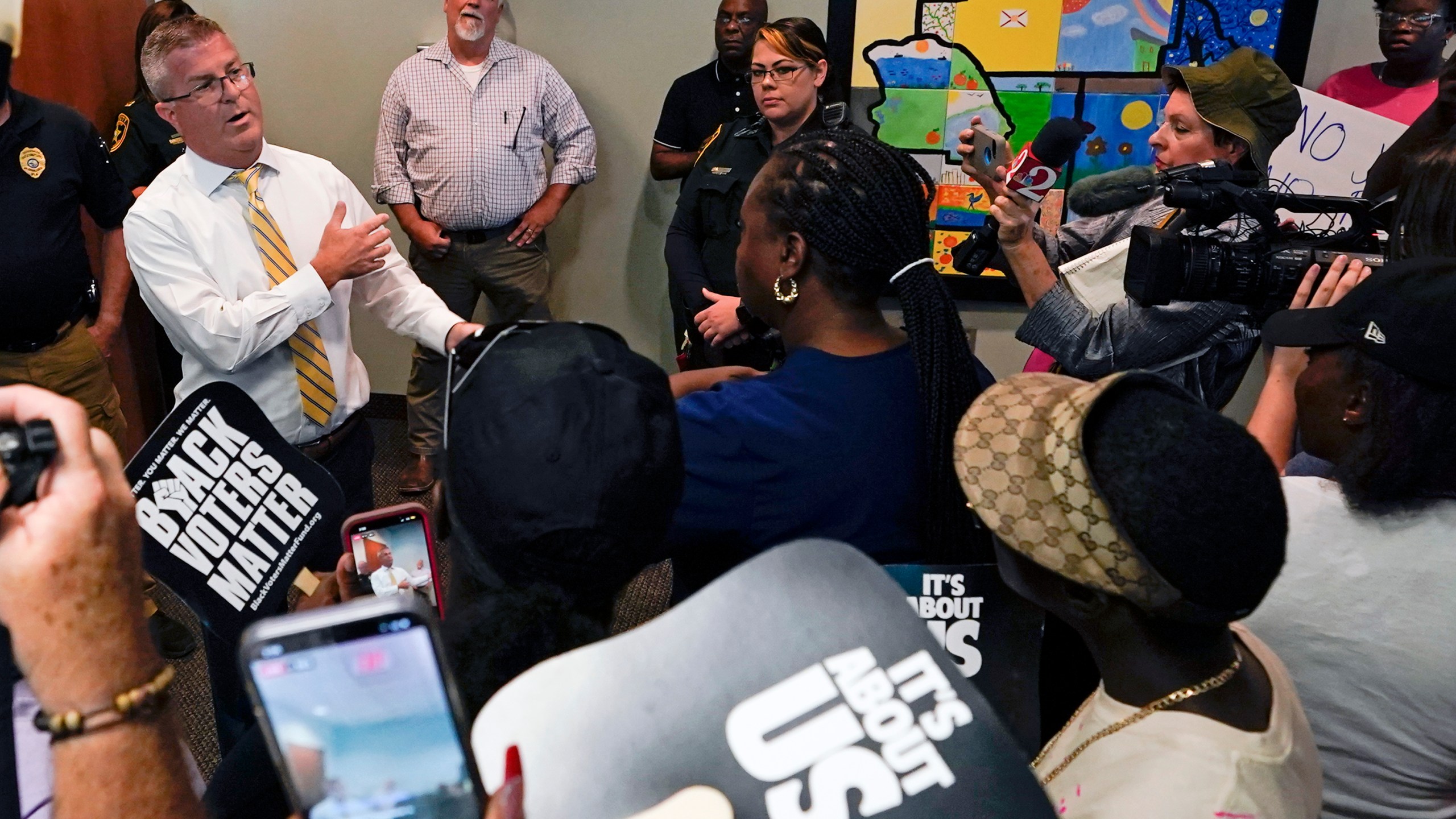 State Attorney William Gladson, left, speaks to a group of protesters and the media outside his office at the Marion County Courthouse, Tuesday, June 6, 2023, in Ocala, as protesters demand the arrest of a woman who shot and killed Ajike Owens, a 35-year-old mother of four, last Friday night, June 2. Authorities came under intense pressure Tuesday to bring charges against a white woman who killed Owens, a Black neighbor, on her front doorstep, as they navigated Florida’s divisive stand your ground law that provides considerable leeway to the suspect in making a claim of self defense. (AP Photo/John Raoux)