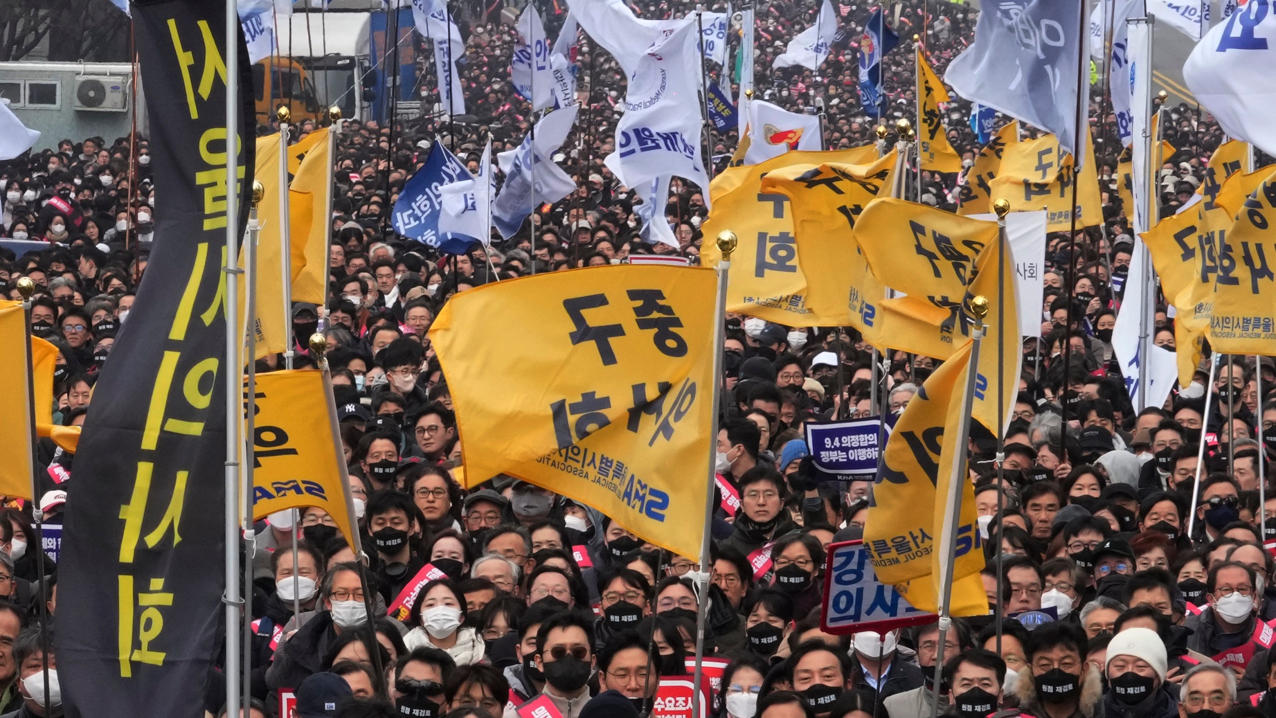 Doctors stage a rally against the government's medical policy in Seoul, South Korea, Sunday, March 3, 2024. South Korean officials said Tuesday they are seeking to get the leaders of thousands of striking junior doctors to face police investigations as part of legal repercussions for their walkouts that have disrupted hospital operations. (AP Photo/Ahn Young-joon)