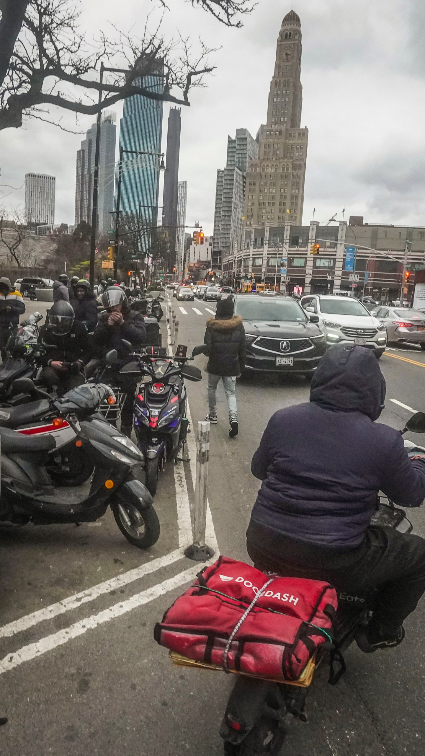 Food delivery workers gather for pickups outside fast-food restaurants on Brooklyn's Flatbush Avenue, Monday, Jan. 29, 2024, in New York. Recent city ordinances in New York and Seattle have increased minimum wage protections for app-based food delivery workers. (AP Photo/Bebeto Matthews)