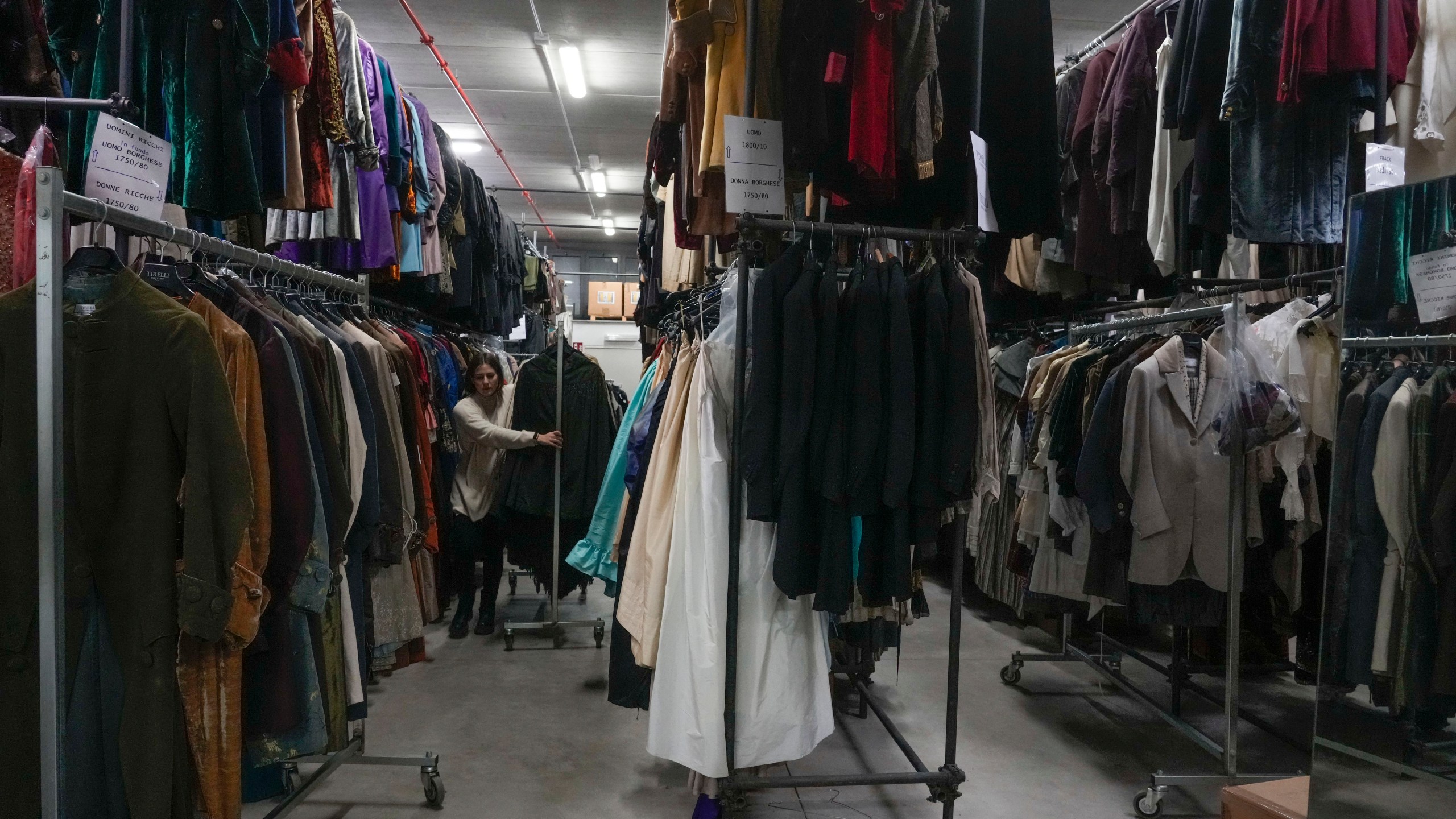 Dresses hang at the Tirelli's warehouse in Formello near Rome, Tuesday, March 5, 2024. For nearly six decades, the Tirelli atelier in Rome has woven itself into the fabric of Italian and international film history, earning the nickname the "Oscar tailor's shop" for its contribution to cinematic costume design. Established in November 1964, the shop on a quiet Roman street has been behind 17 Academy Awards for Best Costume Design. (AP Photo/Gregorio Borgia)