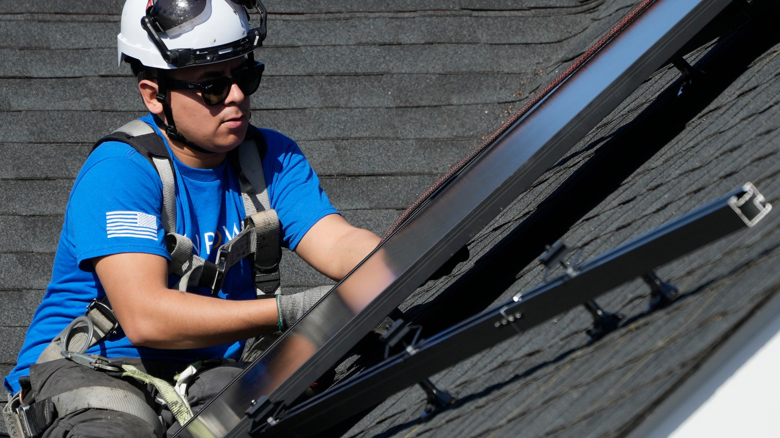 A technician installs solar panels on a roof of a home in Arlington Heights, Ill., Monday, Feb. 26, 2024. On Wednesday, March 6, 2024, the Labor Department reports on job openings and labor turnover for January. (AP Photo/Nam Y. Huh)