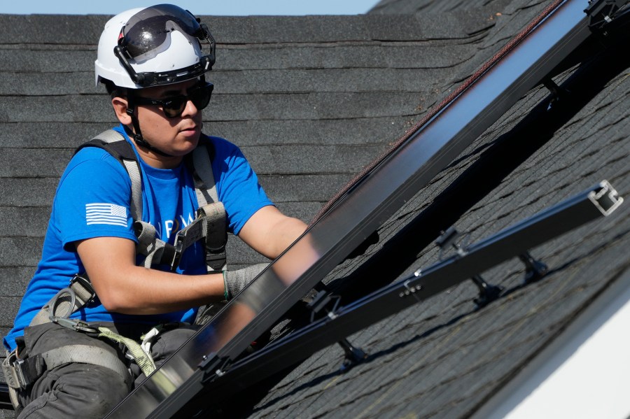 A technician installs solar panels on a roof of a home in Arlington Heights, Ill., Monday, Feb. 26, 2024. On Wednesday, March 6, 2024, the Labor Department reports on job openings and labor turnover for January. (AP Photo/Nam Y. Huh)