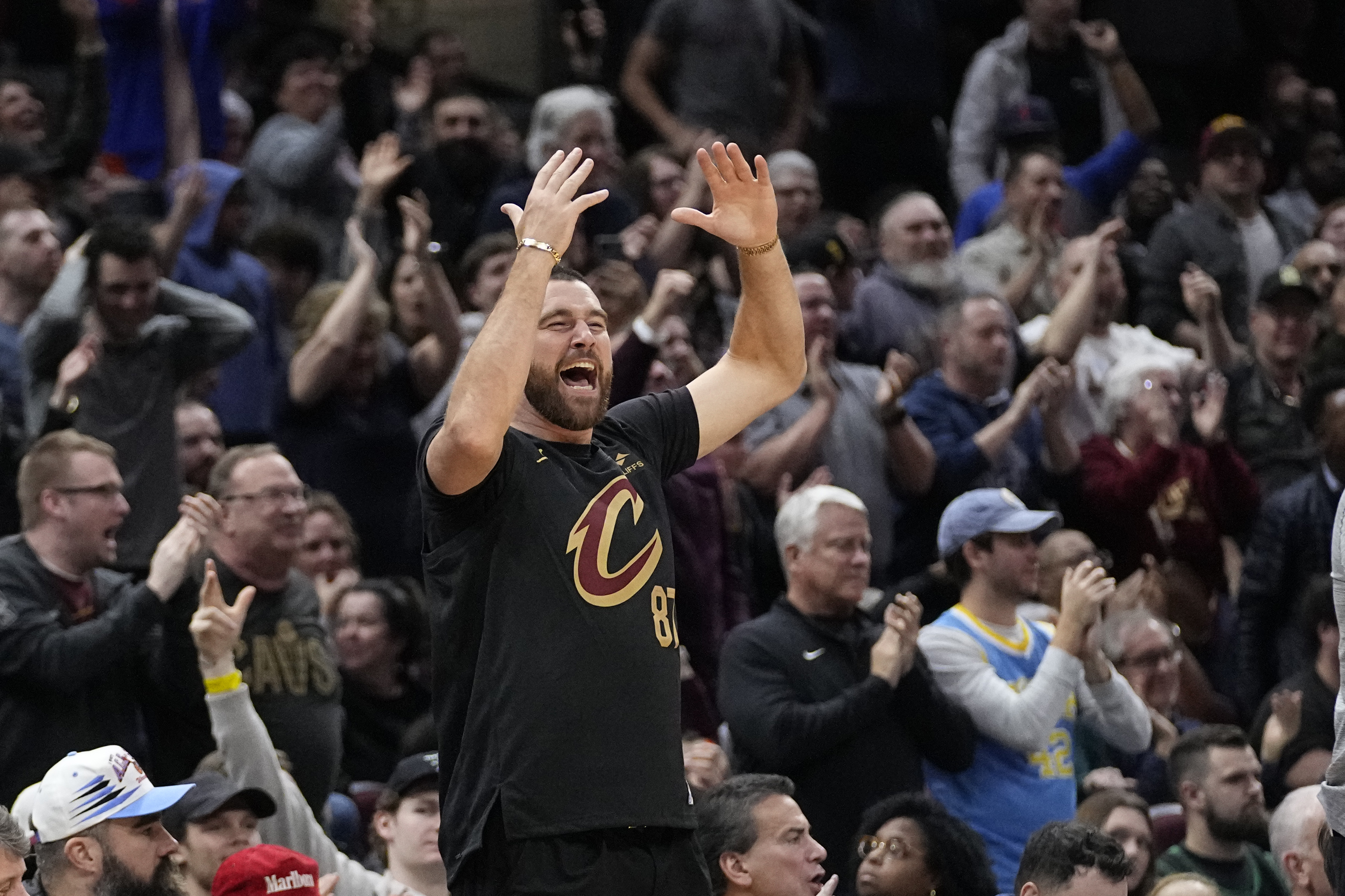 Travis Kelce cheers from courtside in the second half of an NBA basketball game between the Boston Celtics and the Cleveland Cavaliers, Tuesday, March 5, 2024, in Cleveland. (AP Photo/Sue Ogrocki)