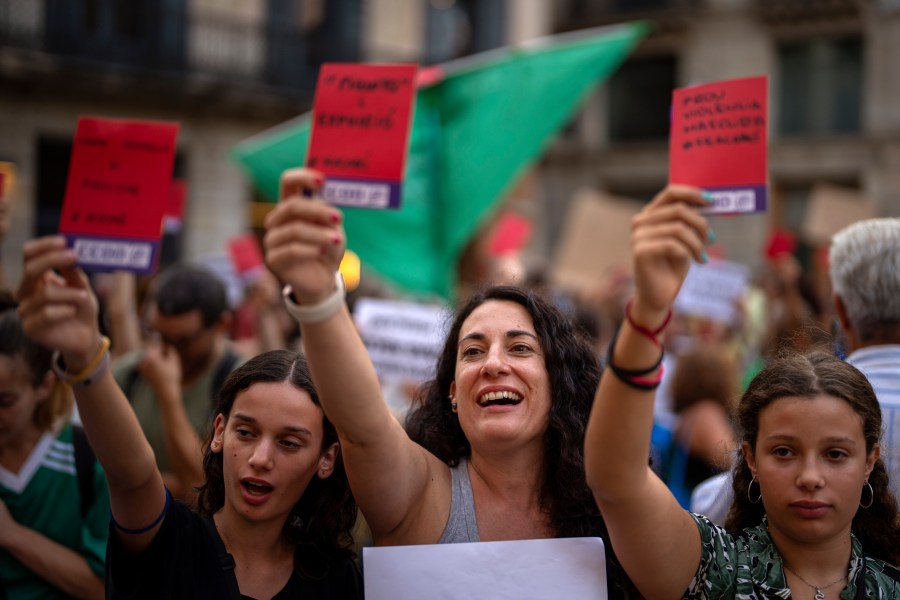 FILE - Demonstrators shouts slogans during a protest against the President of Spain's soccer federation Luis Rubiales and to support Spain's national women's soccer player Jenni Hermoso in Barcelona, Spain, Monday, Sept. 4, 2023. The Spanish soccer federation and Barcelona soccer club have been fined an undisclosed sum by Spain’s labor ministry for not meeting workplace regulations regarding gender equality. The ministry says that the federation did not have the required gender equality plan or sexual harassment protocols in place when Spain won last year's Women's World Cup. (AP Photo/Emilio Morenatti, File)